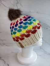 Load image into Gallery viewer, Lotus flower beanie in natural ivory wool with various rainbow colored flower rows. Brownish grey pom on top.