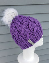 Load image into Gallery viewer, Bright purple cable effect beanie topped with a white faux fur pom.