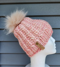 Load image into Gallery viewer, Braided hearts beanie in a pink color yarn. Topped with blush faux fur pom.
