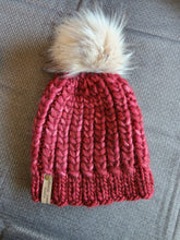 Load image into Gallery viewer, Braided hearts beanie in a red color yarn. Topped with tan faux fur pom.
