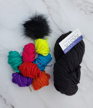 Load image into Gallery viewer, Small colorful yarn balls next to full skein of Malabrigo Rasta plus a faux fur pom.