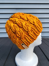 Load image into Gallery viewer, Pumpkin orange braided effect beanie with small greenish crown. No pom.
