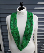 Load image into Gallery viewer, Infinity scarf in bright green yarn with pops of red and sparkles. 
