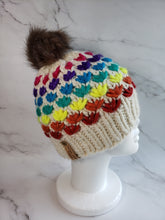 Load image into Gallery viewer, Lotus flower beanie in natural ivory wool with various rainbow colored flower rows. Brownish grey pom on top.
