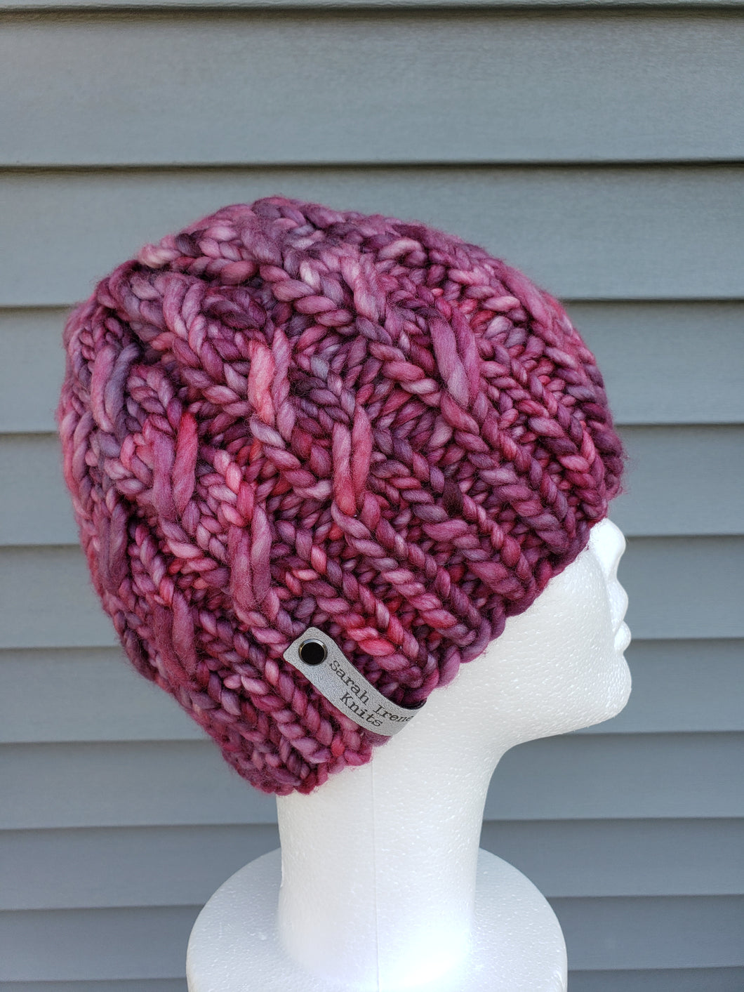 Cable effect beanie in pink, rose, and purple multicolor. No pom.