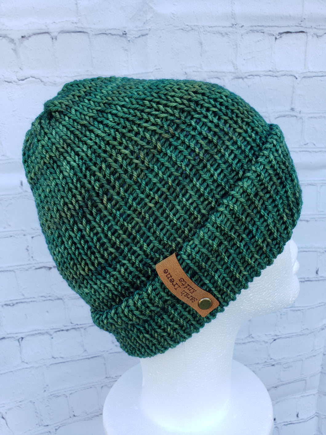 Double brim beanie in multiple shades of green. No pom.