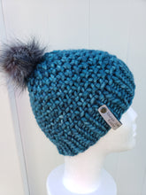 Load image into Gallery viewer, Knobby beanie in teal topped with a faux fur pom.
