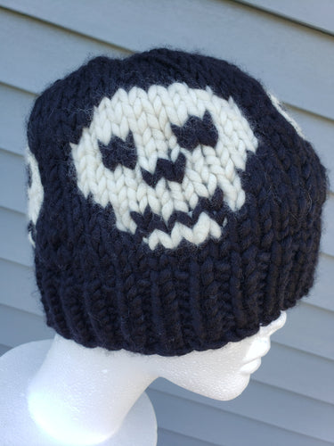 Classic black beanie with an ivory skull design around it.