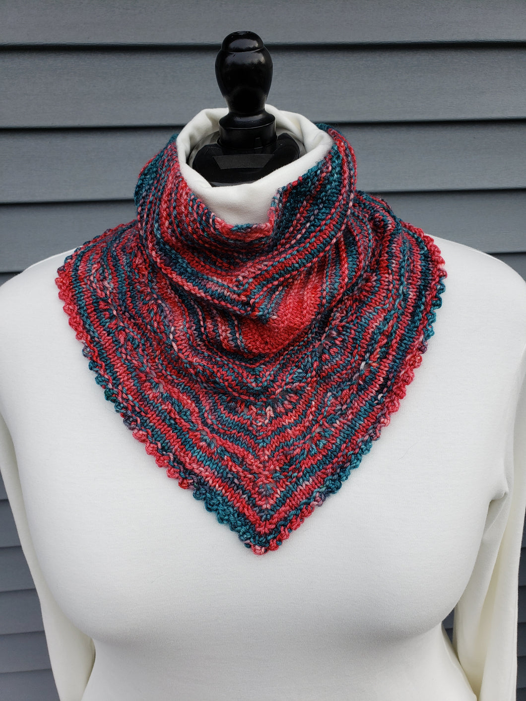Lacy cowl in red and green variegated yarn.