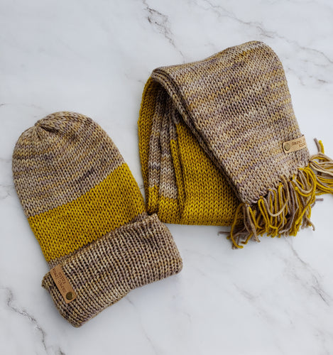Beanie and scarf in matching yellow ochre and grey with yellow speckles.