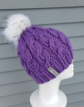 Load image into Gallery viewer, Bright purple cable effect beanie topped with a white faux fur pom.
