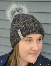 Load image into Gallery viewer, Woman wearing textured multicolor grey blue green beanie with grey faux fur pom on top.
