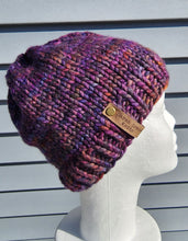 Load image into Gallery viewer, Classic beanie in a variegated purple, red, rust colored 100% Merino wool yarn. No pom.
