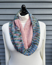 Load image into Gallery viewer, Infinity scarf in multicolor yarn with blues, greens, and pinks plus a block of solid pink yarn.

