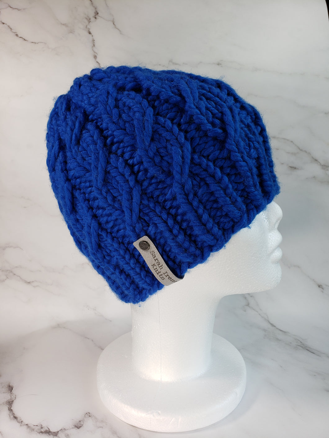 Cable effect beanie in bright blue. No pom.