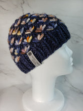 Load image into Gallery viewer, Navy blue lotus flower beanie with yellow, orange, white and blue multicolor flowers. No pom.
